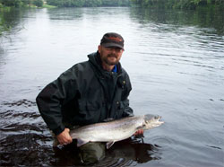 Peter Atteson with a Salmon 6,8 kilo caught on spin fly on July 6. 2002
